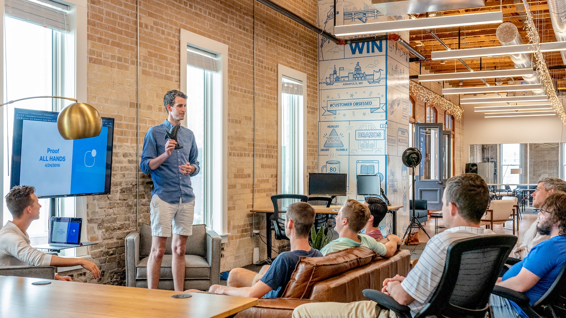 man standing in front of business speaking and collaborating