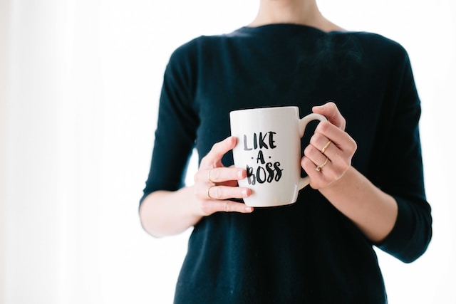 woman holding coffee mug that says "like a boss"