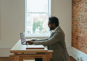 man sitting at home desk working