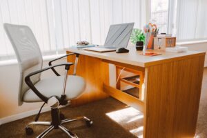 empty chair and desk with laptop